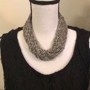 Gray beaded necklace with crochet clasp and button